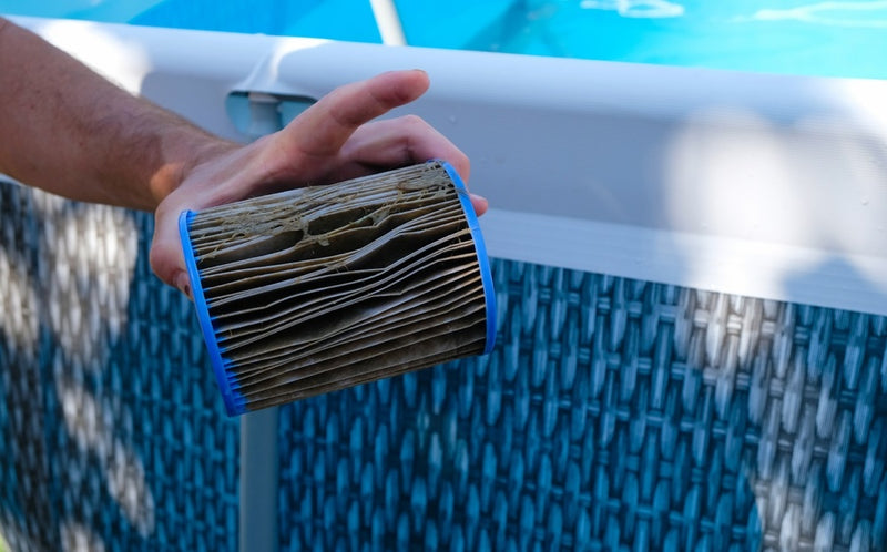 Dirty Replacement Pool Filter Cartridge in a man's hand