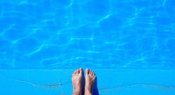 Feet next to an inground pool